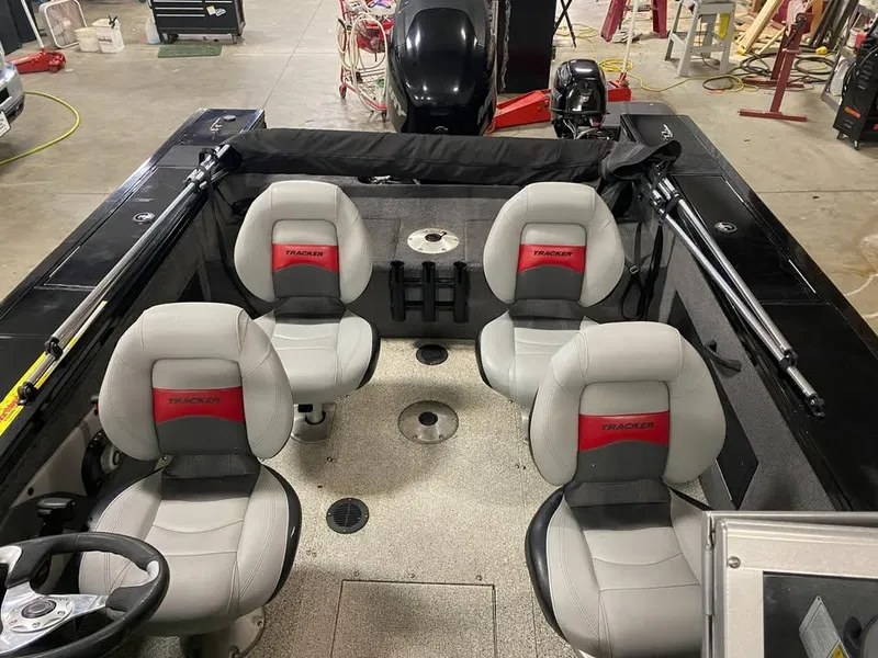 Slide: The Image of 2014 Tracker Targa V-18 WT boat interior with four seats and steering wheel. - 11
