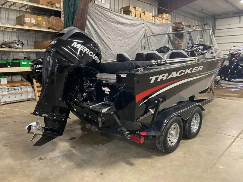 Slide: The Image of 2014 Tracker Targa V-18 WT boat with Mercury engine in a storage facility. - 2