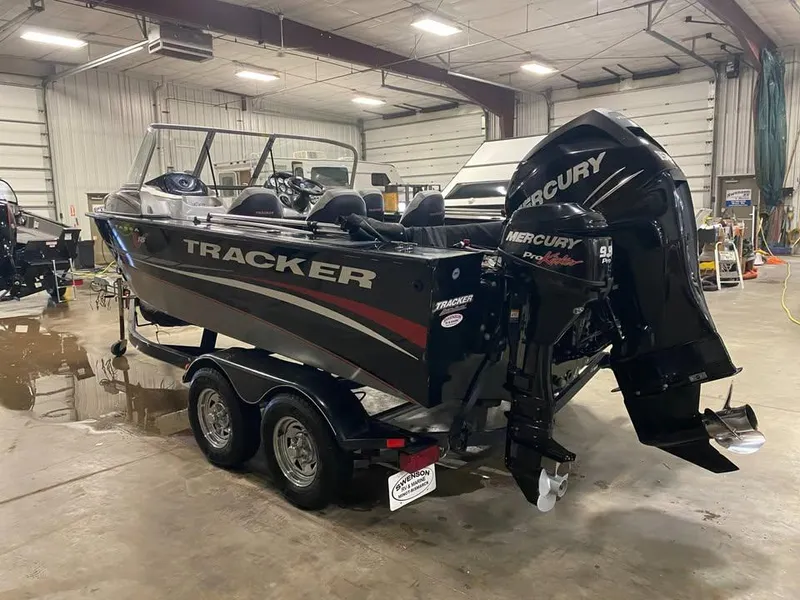 Slide: The Image of 2014 Tracker Targa V-18 WT boat with Mercury engine in a garage setting. - 3