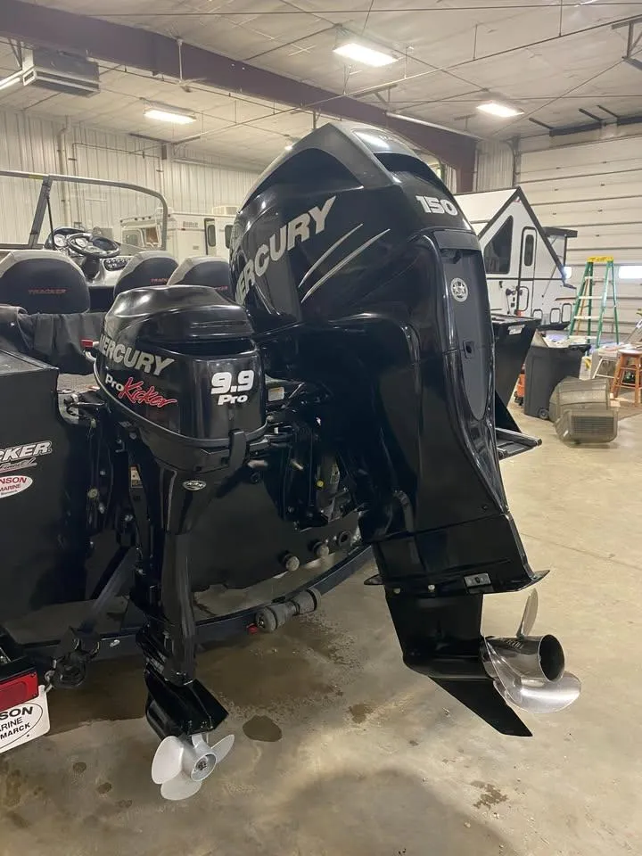 Slide: The Image of 2014 Tracker Targa V-18 WT boat with Mercury outboard motors in a garage setting. - 4