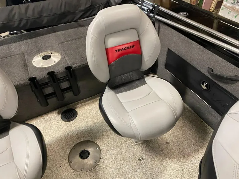 Slide: The Image of 2014 Tracker Targa V-18 WT boat seat with gray upholstery and red Tracker logo. - 6