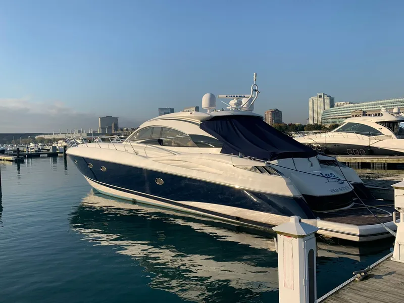 The Image of Sunseeker Predator 61 yacht, 2002 model, docked in a marina under clear skies. - 0