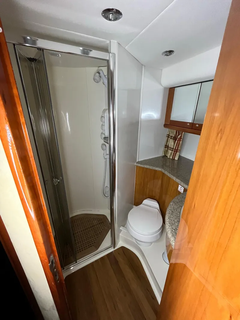 Slide: The Image of Luxurious bathroom in 2002 Sunseeker Predator 61 yacht with shower and wooden accents. - 11