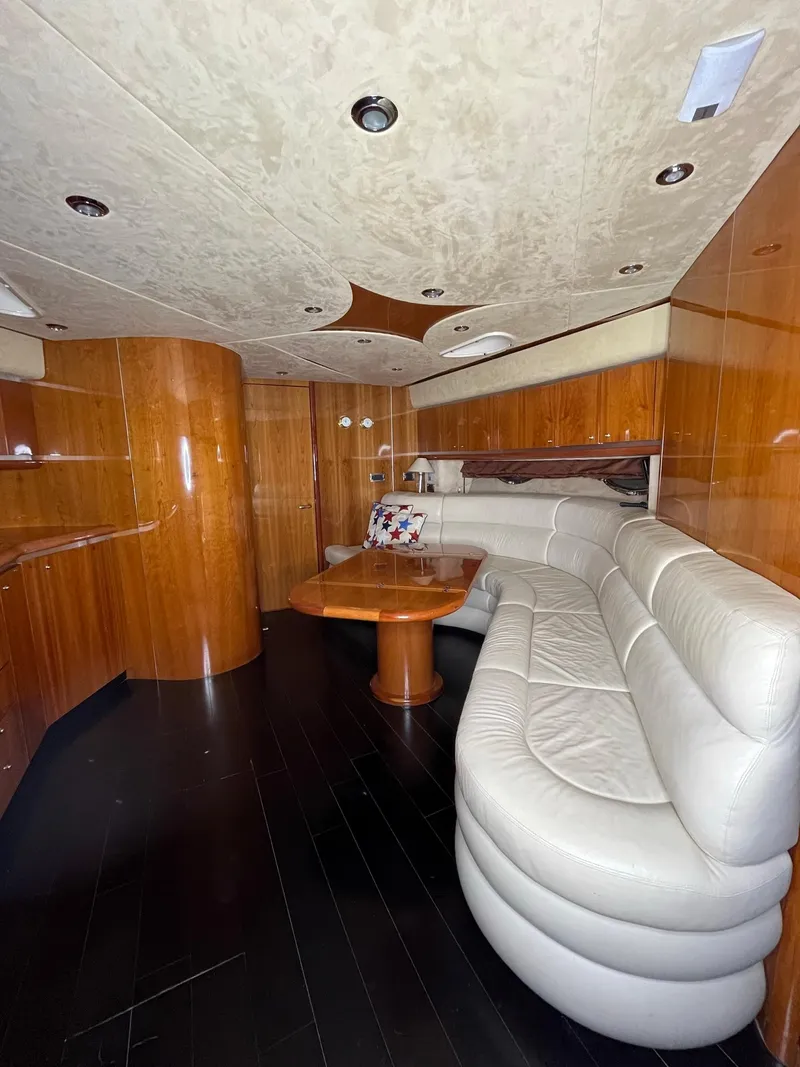 Slide: The Image of Luxurious interior of 2002 Sunseeker Predator 61 yacht with elegant wood paneling and plush seating. - 12