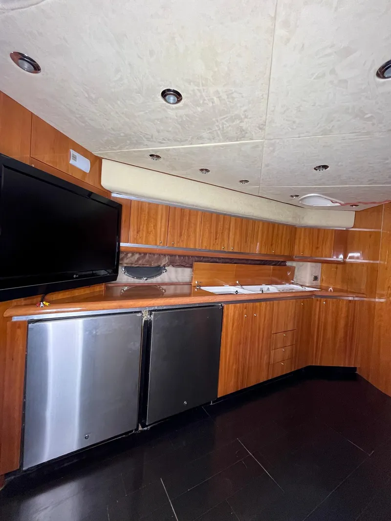 Slide: The Image of Luxurious 2002 Sunseeker Predator 61 yacht interior with modern kitchen and sleek design. - 13
