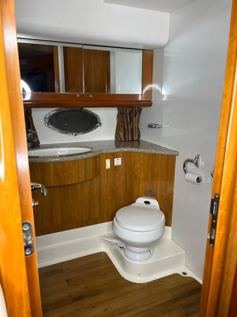 Slide: The Image of Luxurious bathroom in 2002 Sunseeker Predator 61 yacht with wood accents and modern fixtures. - 17
