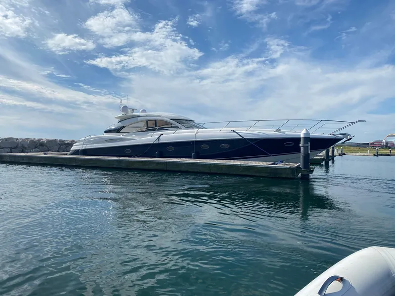Slide: The Image of Sunseeker Predator 61 yacht docked, 2002 model, under a partly cloudy sky. - 2