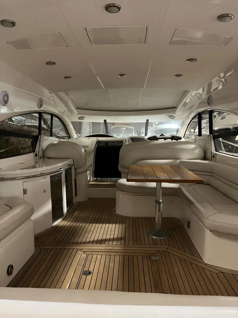 Slide: The Image of Luxurious 2002 Sunseeker Predator 61 yacht interior with elegant seating and wooden flooring. - 29