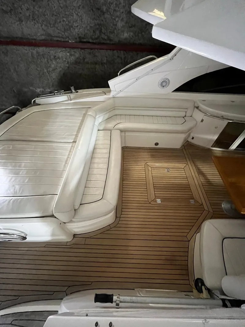 Slide: The Image of Interior of 2002 Sunseeker Predator 61 yacht with white seating and wooden flooring. - 31