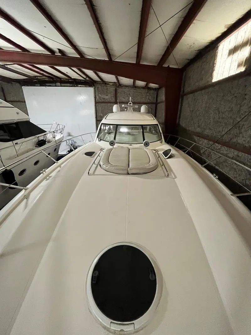 Slide: The Image of 2002 Sunseeker Predator 61 yacht in storage, showcasing sleek design and spacious deck. - 36
