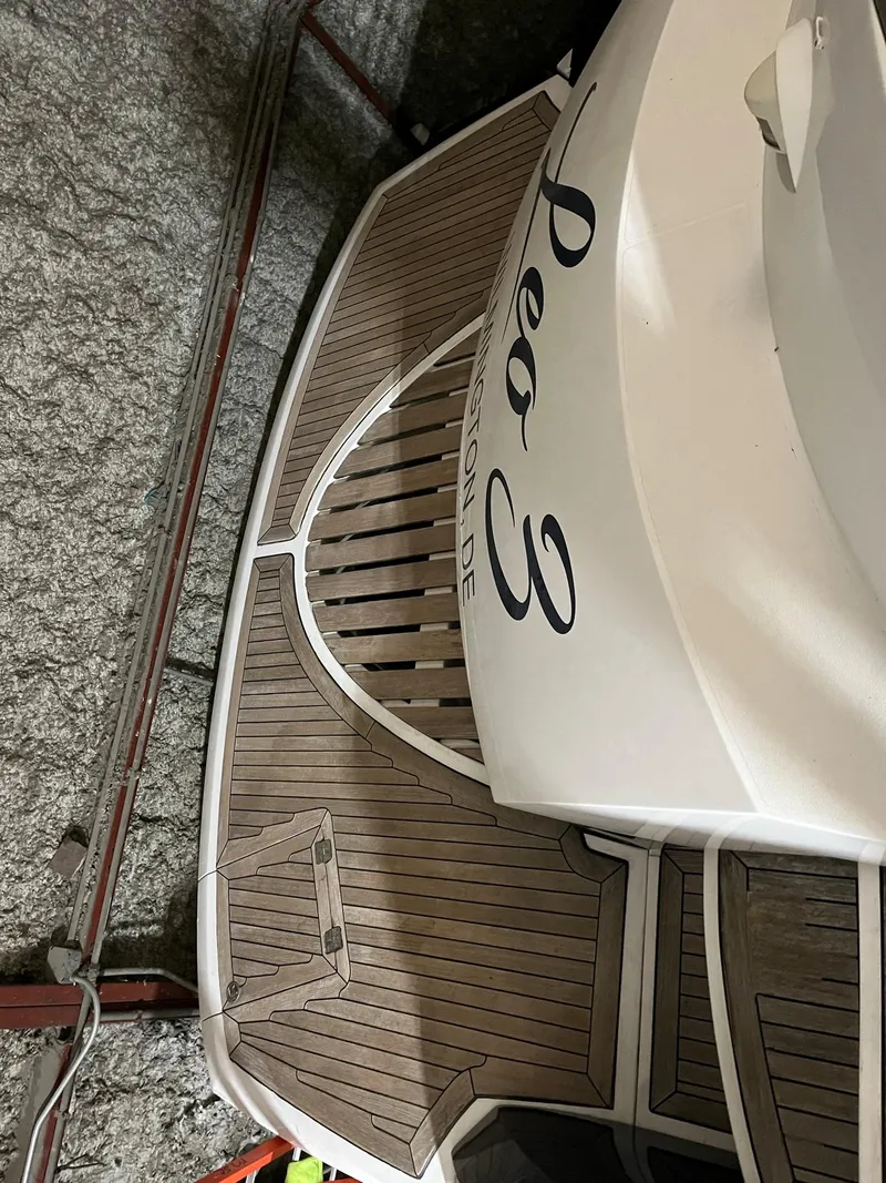 Slide: The Image of Sunseeker Predator 61 yacht, 2002 model, featuring elegant wooden deck design. - 38