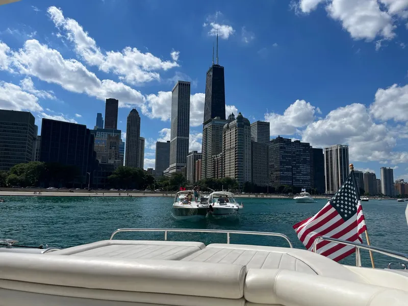 Slide: The Image of Sunseeker Predator 61 yacht cruising near Chicago skyline, 2002 model, with American flag. - 5