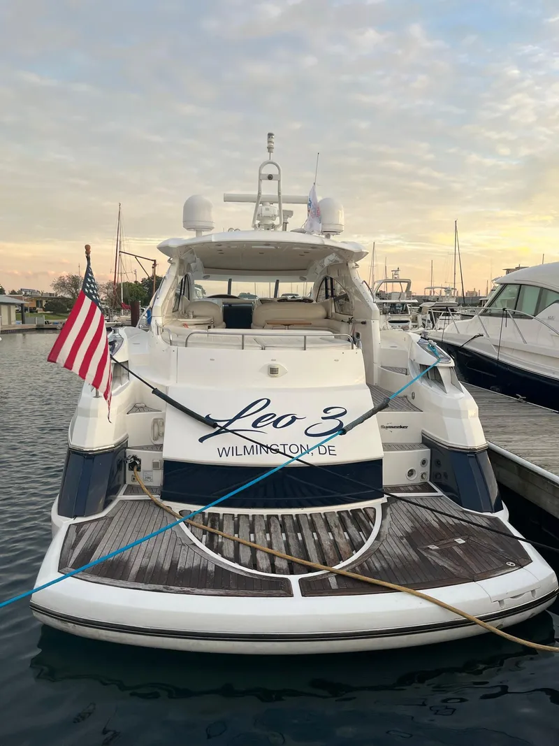 Slide: The Image of 2002 Sunseeker Predator 61 yacht docked, displaying American flag and "Leo 3" name. - 6