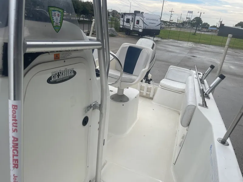 Slide: The Image of 2000 Hydra-Sports 212 Seahorse boat interior with seating and console, parked outdoors. - 16