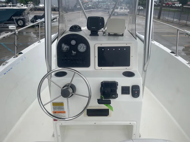 Slide: The Image of 2000 Hydra-Sports 212 Seahorse boat dashboard with steering wheel and navigation instruments. - 19