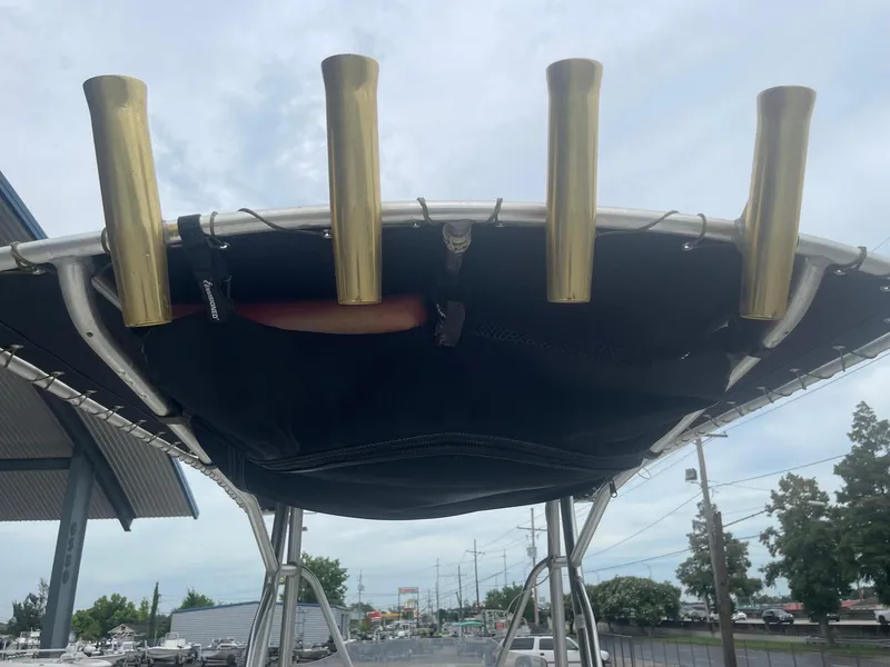 Slide: The Image of Hydra-Sports 212 Seahorse 2000 boat with rod holders and canopy, outdoor setting. - 20