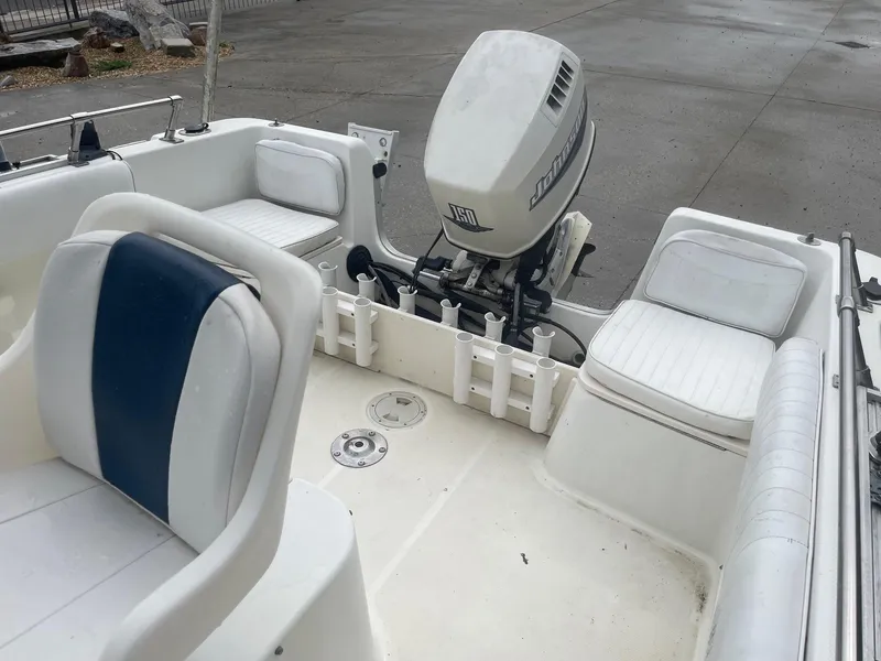 Slide: The Image of 2000 Hydra-Sports 212 Seahorse boat interior with seating and outboard motor. - 22