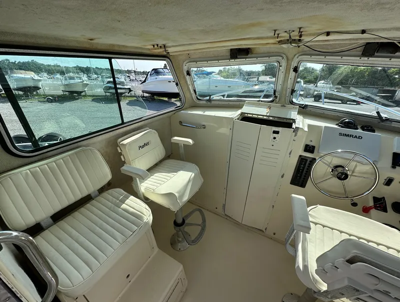Slide: The Image of Interior of 2004 Parker 2520 Deep Vee Sport Cabin boat with seating and control panel. - 11
