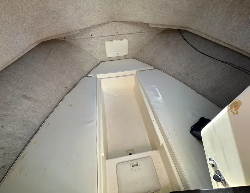 Slide: The Image of 2004 Parker 2520 Deep Vee Sport Cabin interior view, showing storage compartments and seating area. - 14