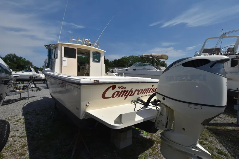 Slide: The Image of 2004 Parker 2520 Deep Vee Sport Cabin boat with Suzuki outboard motor. - 3
