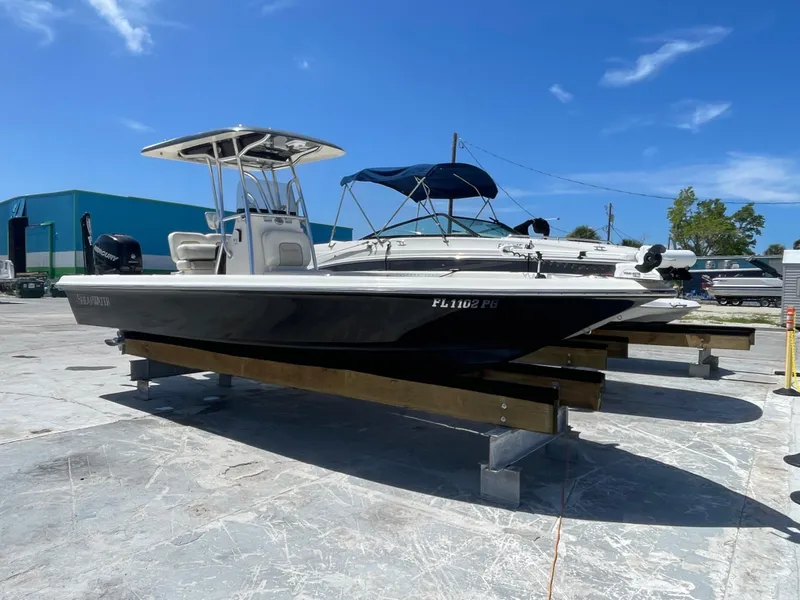 The Image of 2011 ShearWater 25LTZ boat on display under clear blue sky. - 1