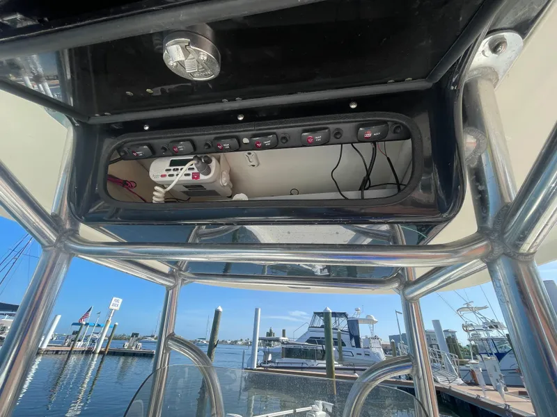 Slide: The Image of 2011 ShearWater 25LTZ boat console with control panel, docked at marina. - 11