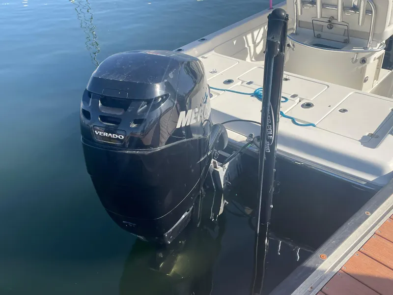 Slide: The Image of 2011 ShearWater 25LTZ boat with Mercury Verado engine docked on calm water. - 15