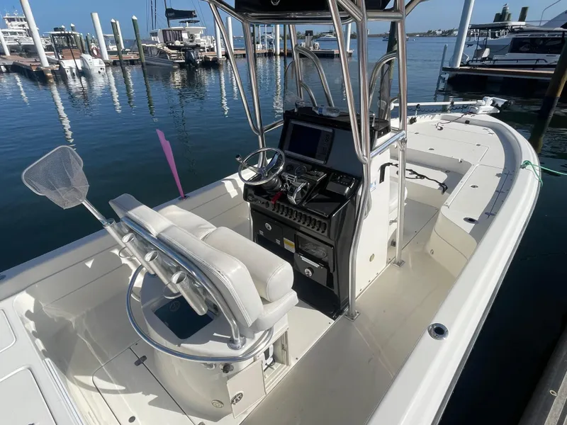 Slide: The Image of 2011 ShearWater 25LTZ boat docked, featuring a sleek console and comfortable seating. - 16