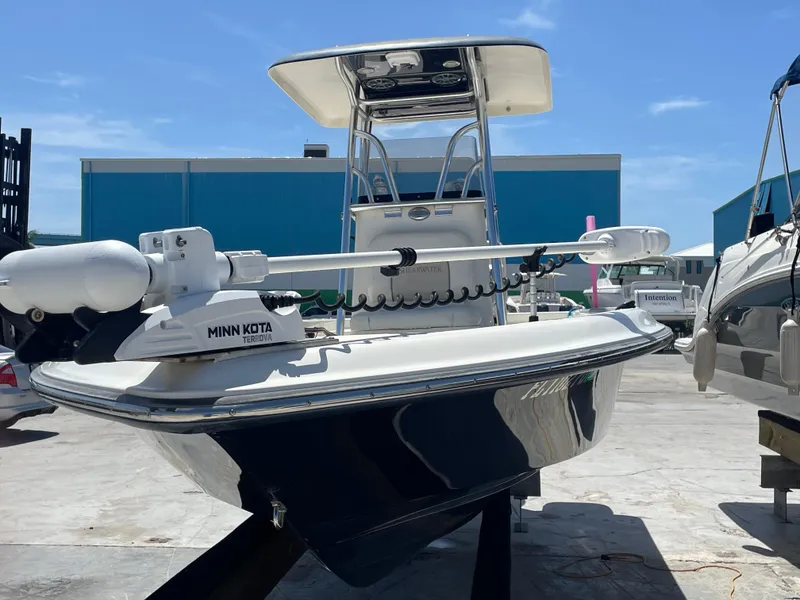 Slide: The Image of 2011 ShearWater 25LTZ boat with Minn Kota trolling motor, docked under clear blue sky. - 3
