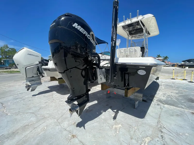 Slide: The Image of 2011 ShearWater 25LTZ boat with Mercury outboard engine, docked on a sunny day. - 5