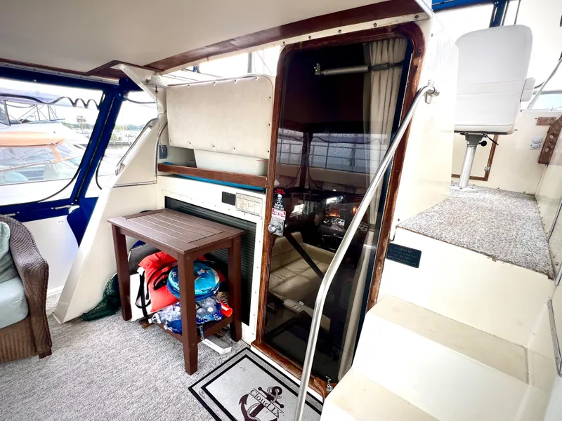 Slide: The Image of 1986 Chris-Craft 480 Corinthian yacht interior with stairs and seating area. - 13