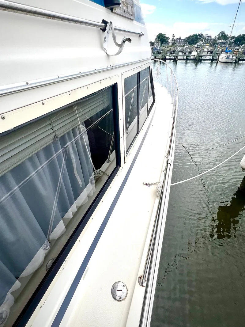 Slide: The Image of 1986 Chris-Craft 480 Corinthian yacht docked at marina, side view. - 17