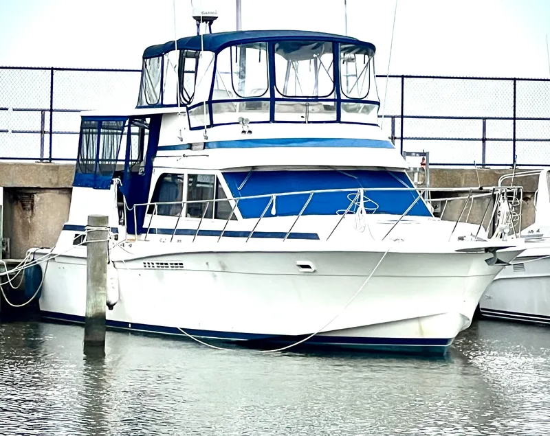 Slide: The Image of 1986 Chris-Craft 480 Corinthian yacht docked in marina. - 2