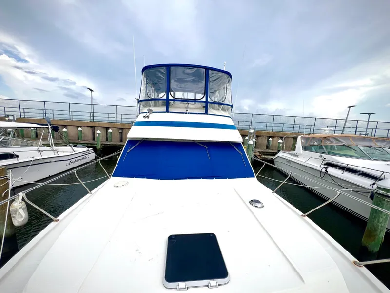 Slide: The Image of 1986 Chris-Craft 480 Corinthian yacht docked at marina, front view. - 22