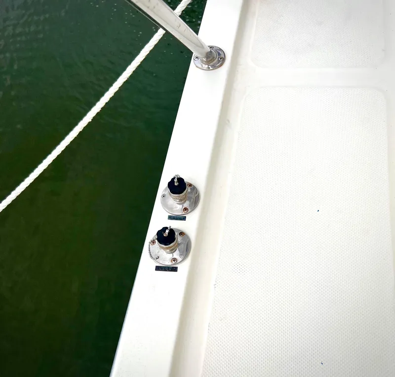 Slide: The Image of Deck of 1986 Chris-Craft 480 Corinthian with railing and fittings, near water. - 26