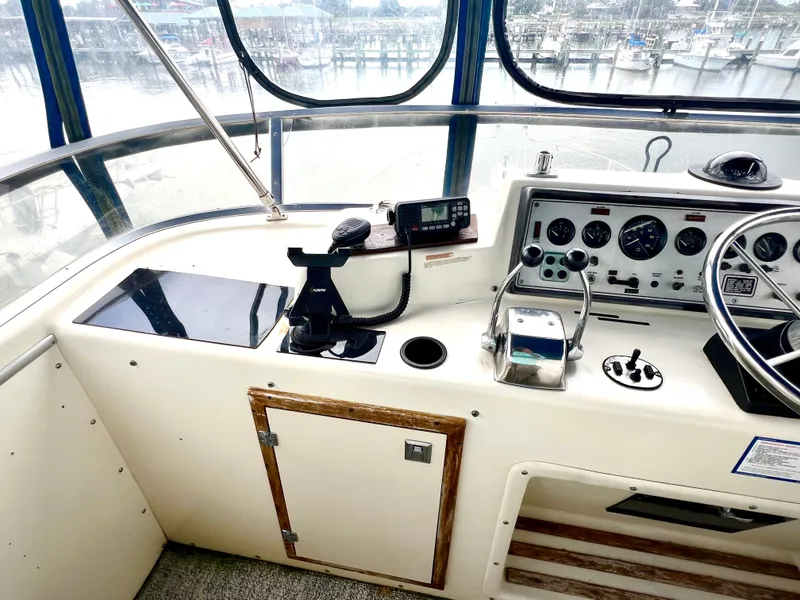Slide: The Image of 1986 Chris-Craft 480 Corinthian helm with navigation instruments and controls. - 33