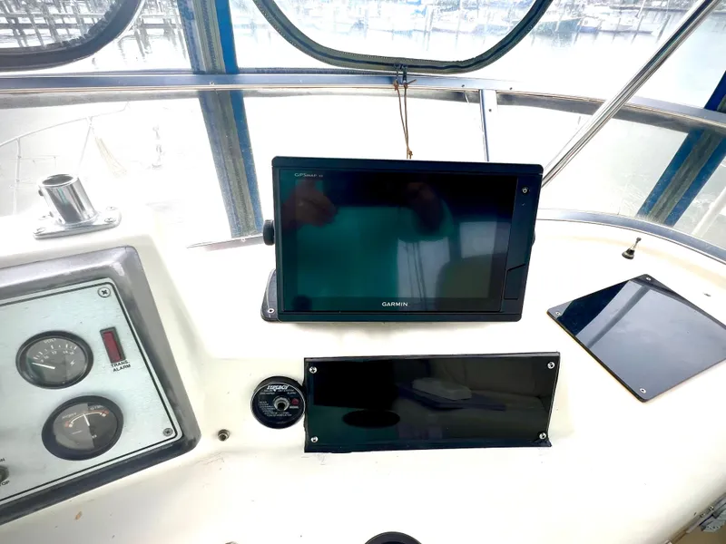 Slide: The Image of 1986 Chris-Craft 480 Corinthian dashboard with navigation equipment and gauges. - 34