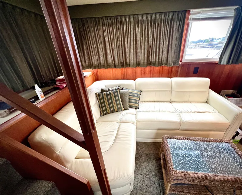 Slide: The Image of Interior of 1986 Chris-Craft 480 Corinthian with white leather sofa and wicker table. - 37