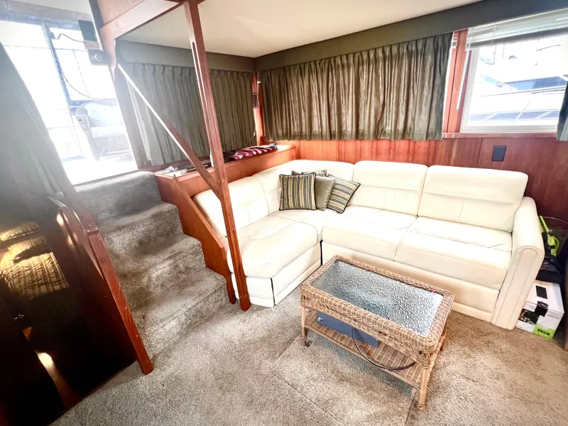 Slide: The Image of Interior of 1986 Chris-Craft 480 Corinthian yacht with white sofa and wicker table. - 38