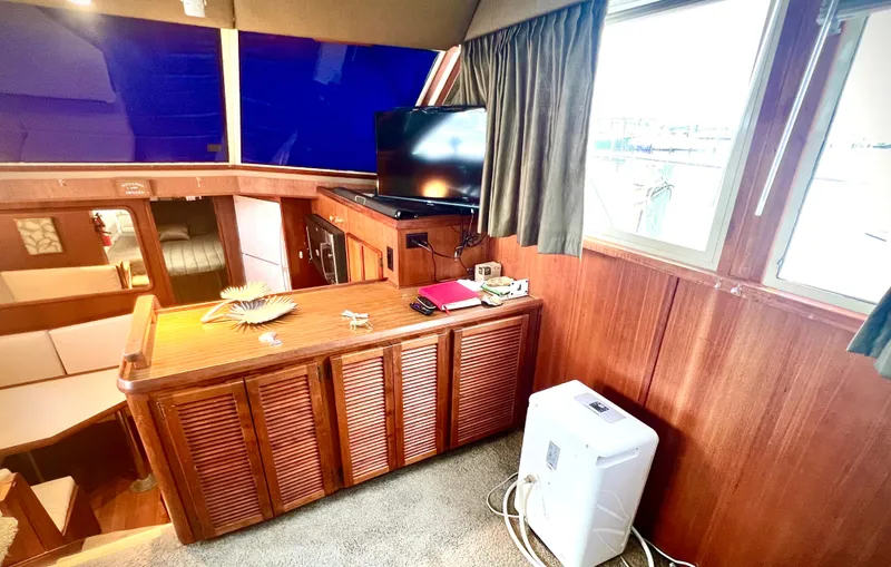 Slide: The Image of Interior of 1986 Chris-Craft 480 Corinthian yacht with wood paneling and modern amenities. - 39