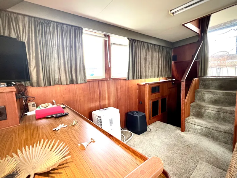 Slide: The Image of Interior of 1986 Chris-Craft 480 Corinthian yacht with wood paneling and carpeted stairs. - 40