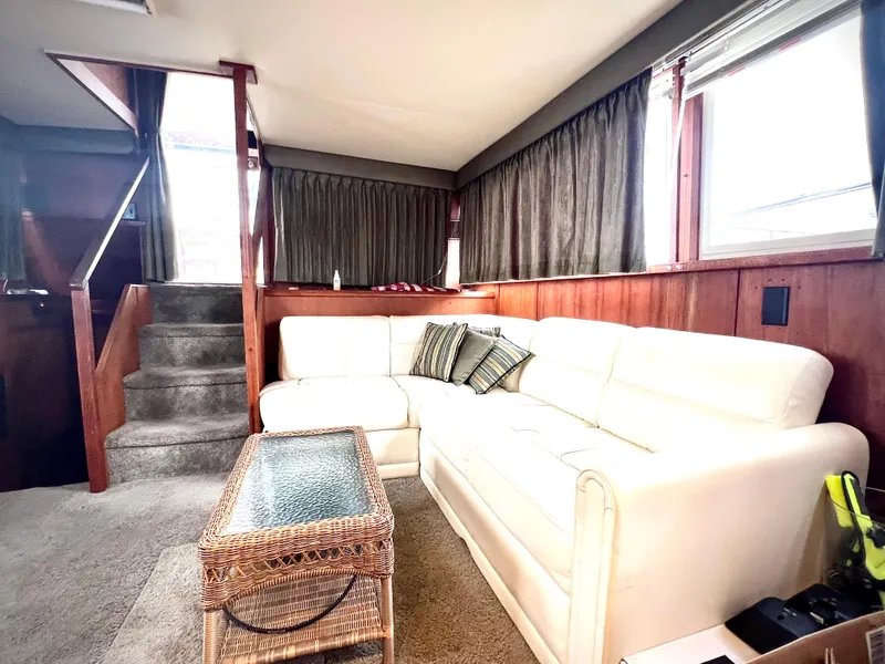 Slide: The Image of Interior of 1986 Chris-Craft 480 Corinthian with white sofa and wicker table. - 41