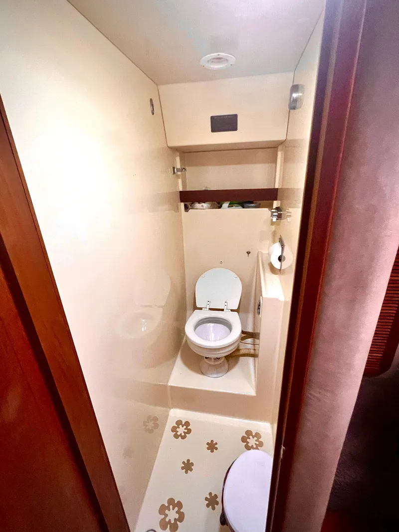 Slide: The Image of 1986 Chris-Craft 480 Corinthian bathroom with floral floor design. - 43