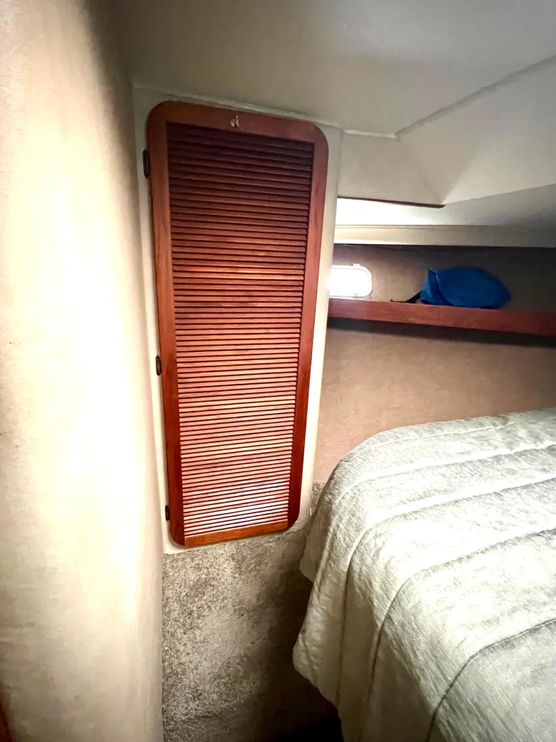 Slide: The Image of 1986 Chris-Craft 480 Corinthian cabin interior with wooden closet and bed. - 44
