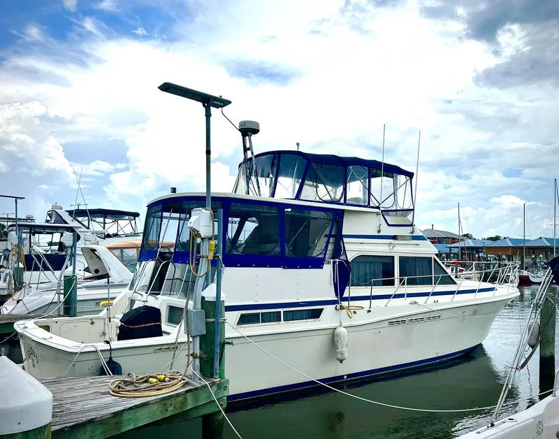 Slide: The Image of 1986 Chris-Craft 480 Corinthian yacht docked at marina under cloudy sky. - 7