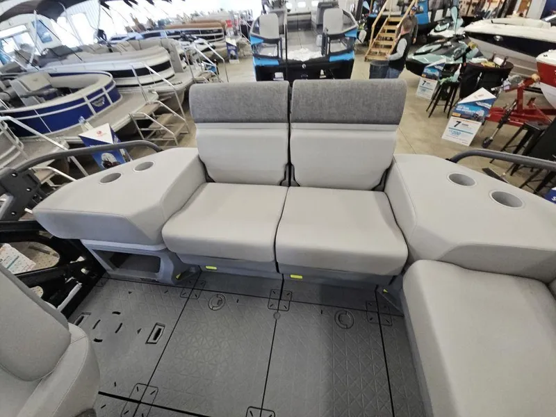 Slide: The Image of 2024 Sea-Doo Switch® Sport Compact interior seating with cup holders in a showroom. - 10