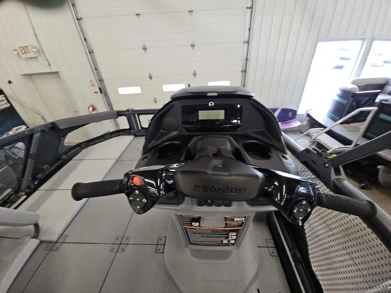Slide: The Image of 2024 Sea-Doo Switch® Sport Compact dashboard and controls in a garage setting. - 5