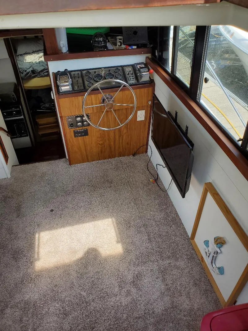 Slide: The Image of 1983 Carver 3207 AFT Cabin Motor Yacht interior with helm, carpet, and windows. - 9