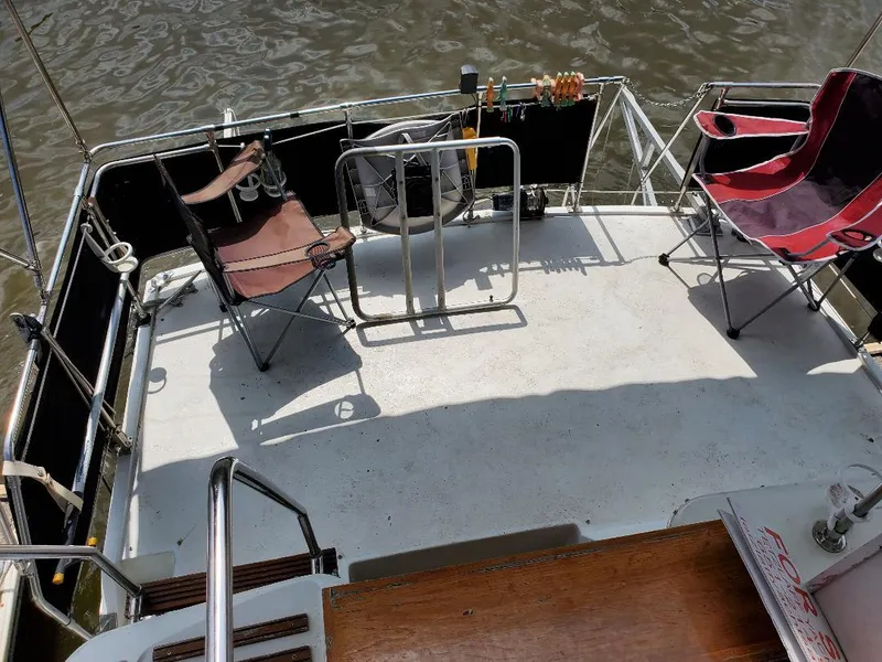 Slide: The Image of 1983 Carver 3207 AFT Cabin Motor Yacht deck with chairs and railing. - 13
