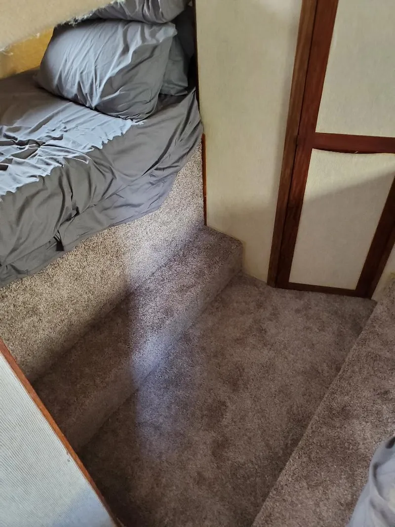 Slide: The Image of Interior of 1983 Carver 3207 AFT Cabin Motor Yacht with carpeted steps and bedding. - 4